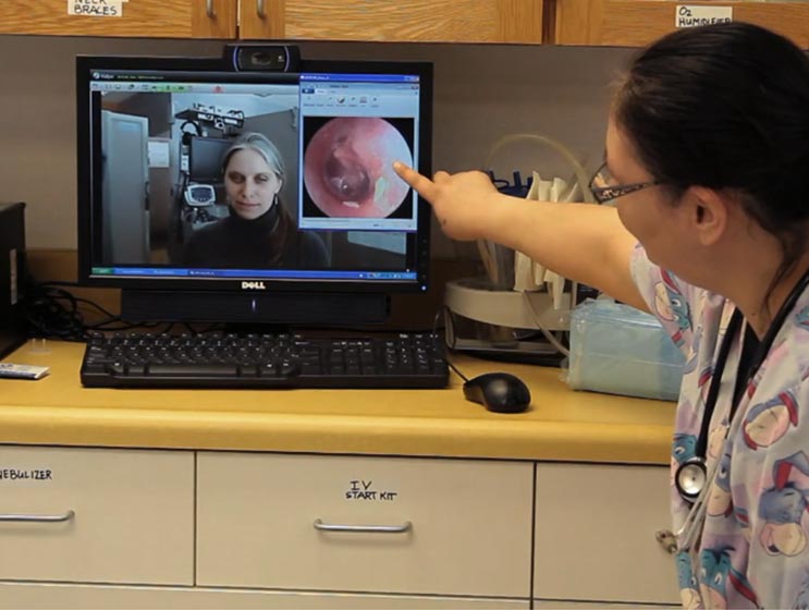 Nurse diagnosing patient remotely through Vidyo