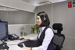 Video banking employee sitting at desk with headset