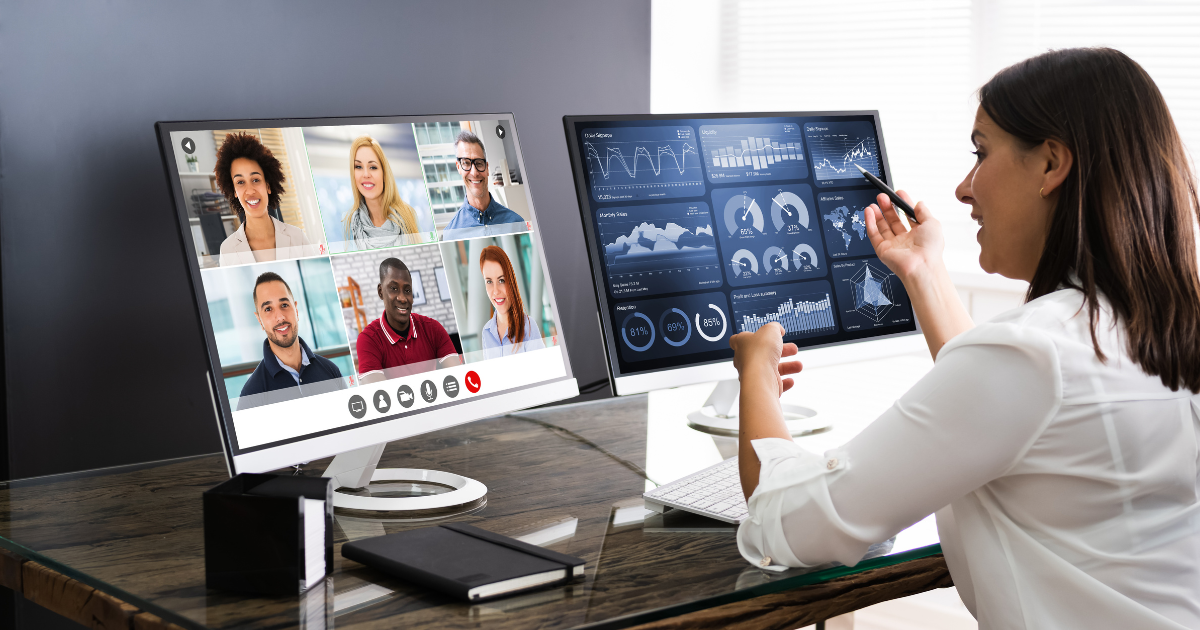 A woman conducting a live presentation using 2 monitors.