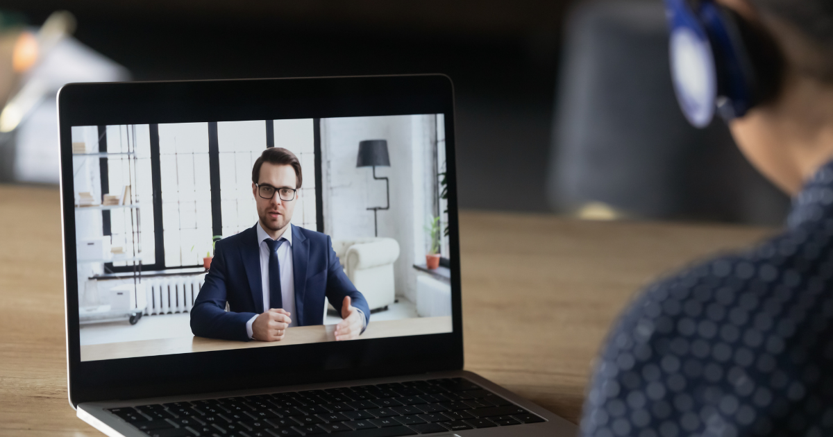 A man in a video banking call with a bank representative on his laptop.