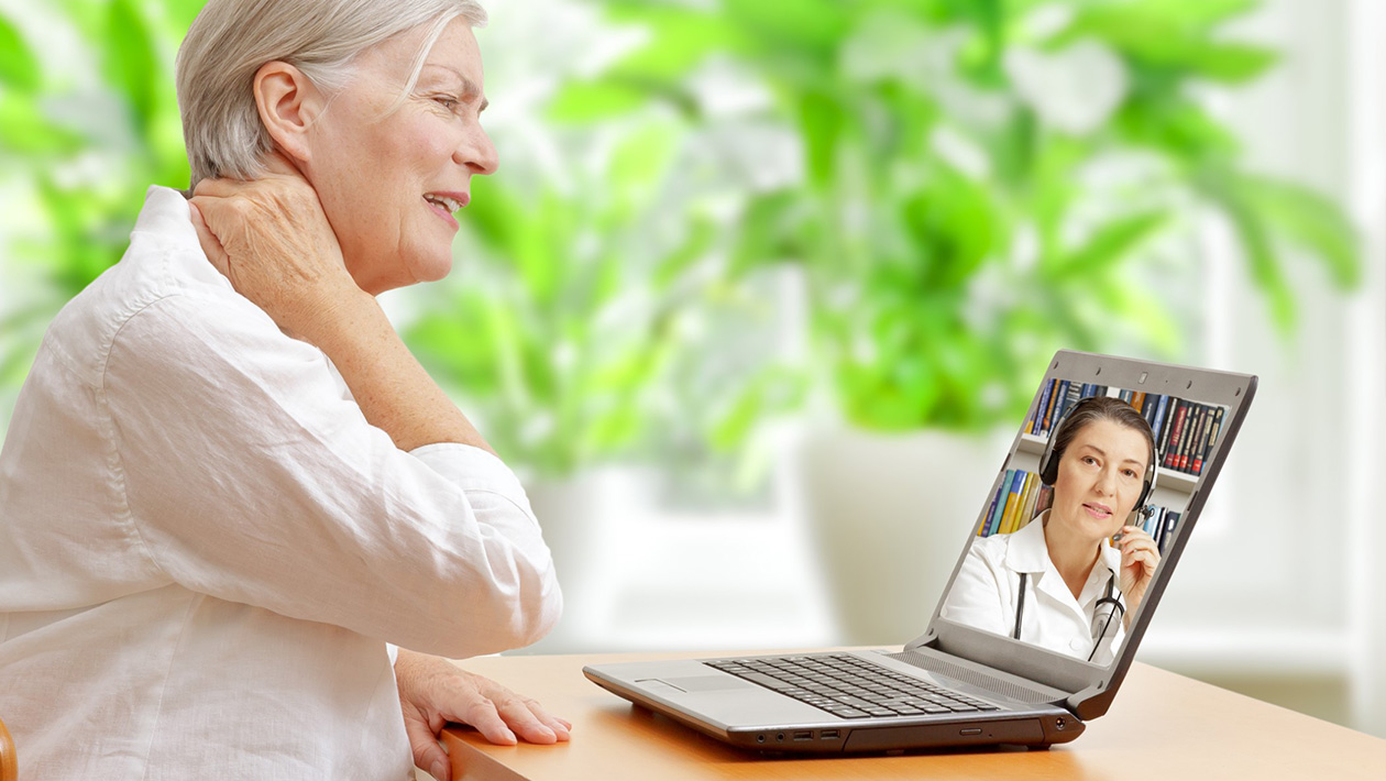 elderly woman video-conferencing with doctor