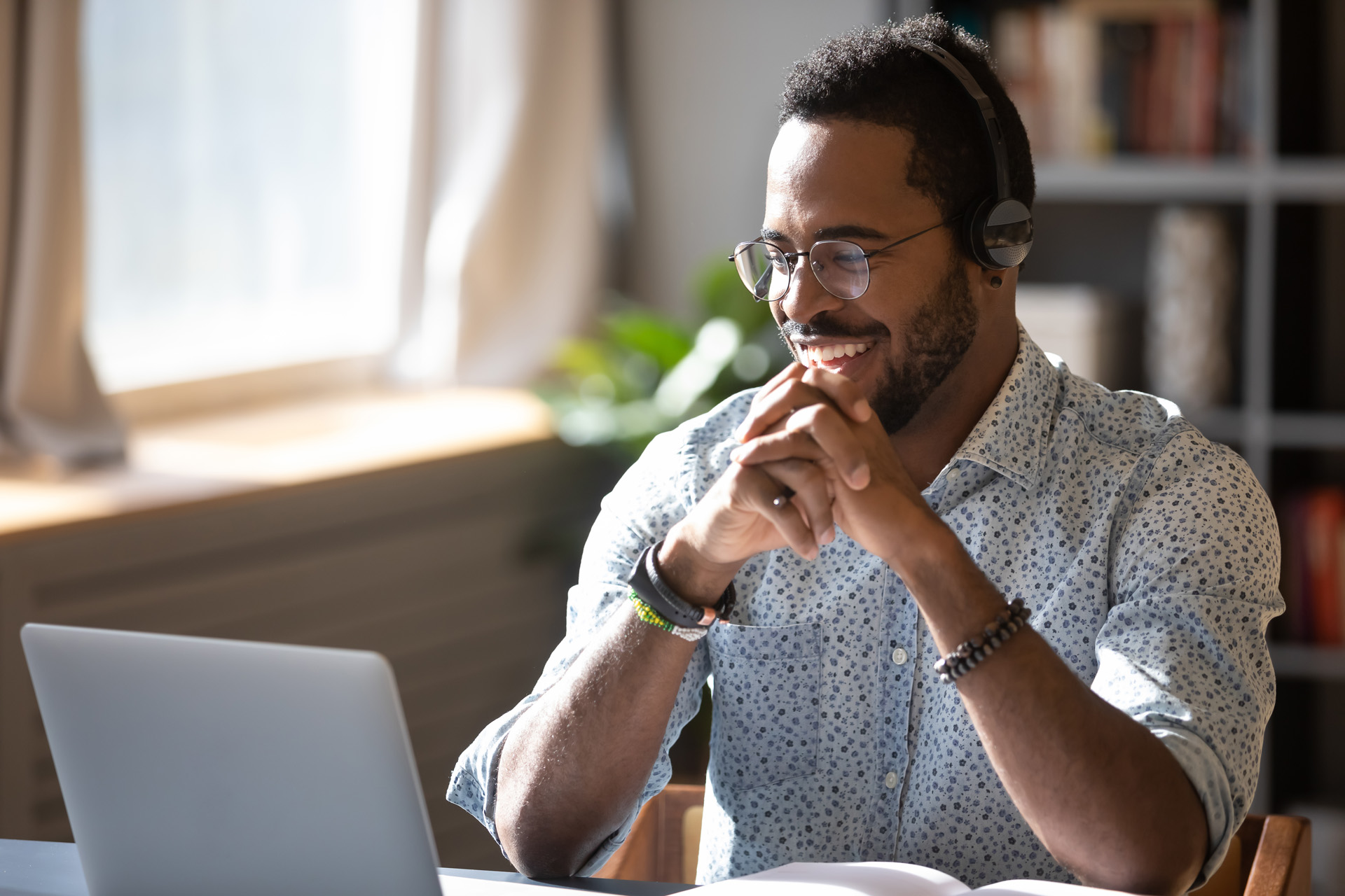 a male customer watching insurance video on his laptop