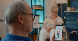 Elderly man on a virtual doctors visit using his phone.