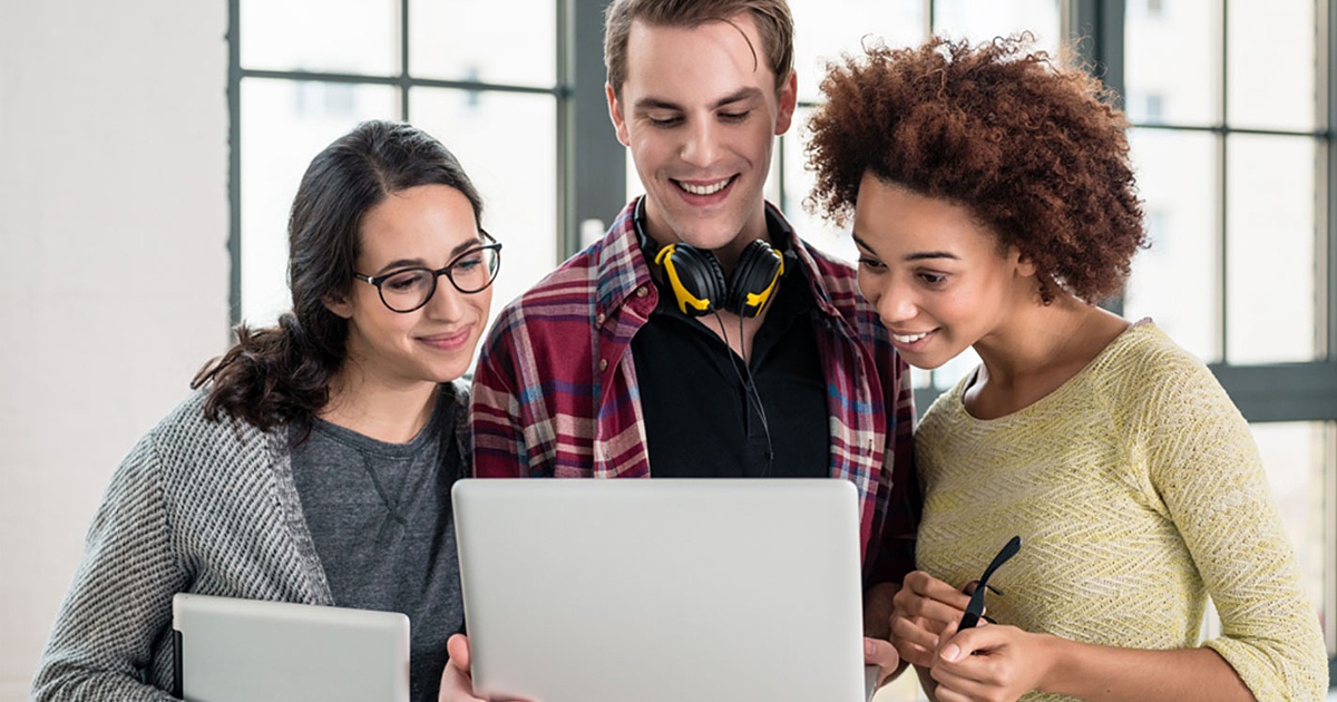 3 employees looking at computer for digital learning