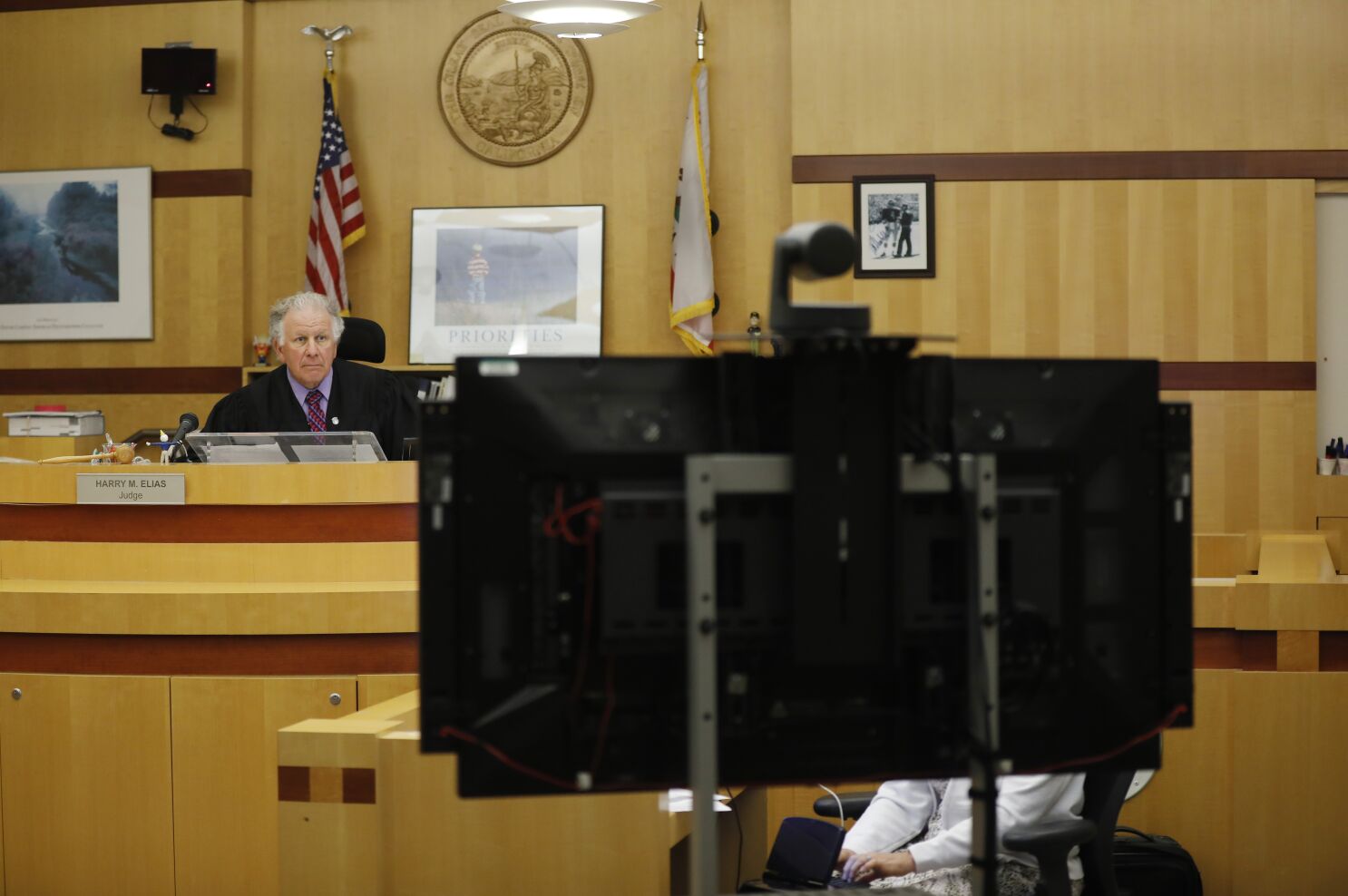 judge looking at tv screen for video conferencing