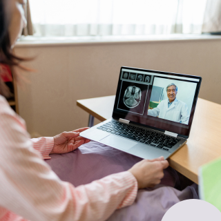 Elderly couple accessing rural healthcare services on a desktop