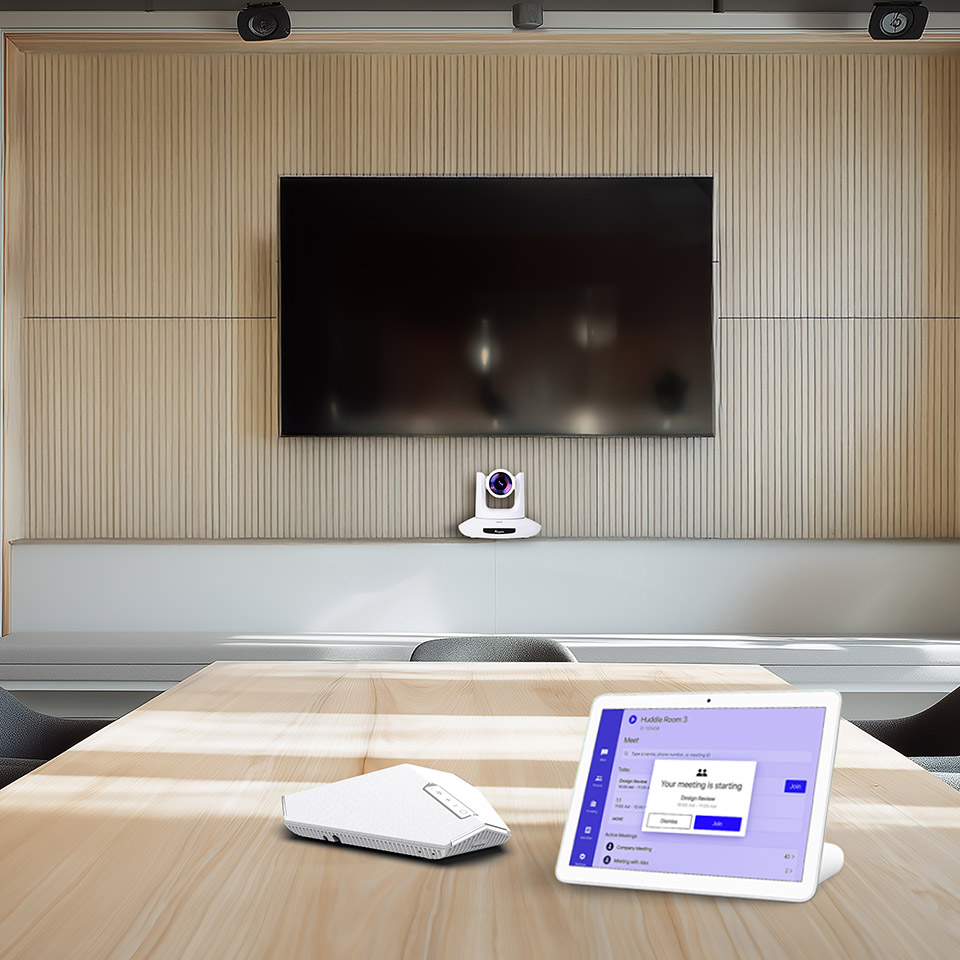 Office meeting with woman on monitor via video conference